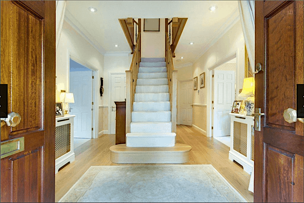 grand central feature oak staircase with white carpet and feature curtail staircase