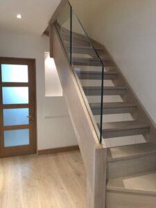 open tread stained oak staircase with modern frameless glass