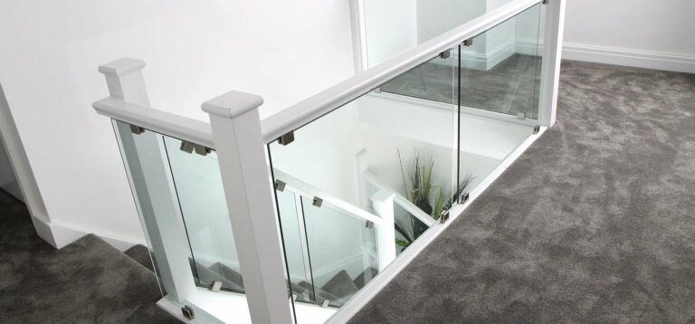 White & Glass staircase and landing area with dark grey carpet