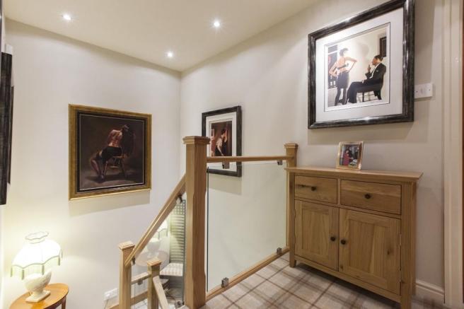 A homely hallway now has a perfectly in-keeping homely staircase with oak & clamped glass.